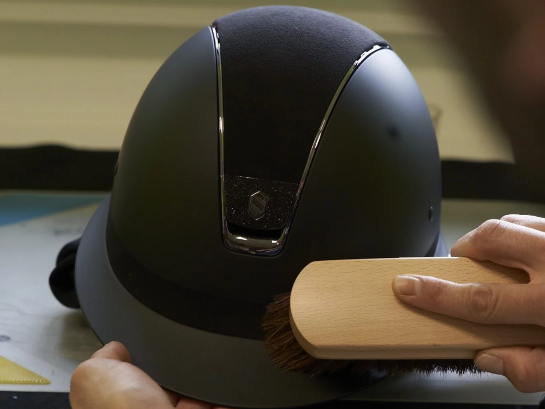 Close up image of a hand cleaning a Samshield helmet