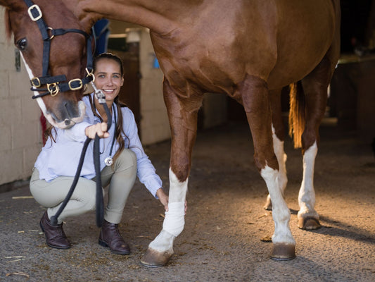Girl and horse with a wrapped leg injury