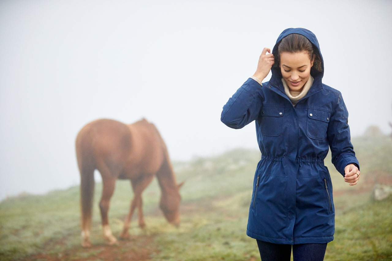 equestrian wearing rain gear