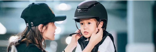 Young child wearing a Kask Equestrian helmet