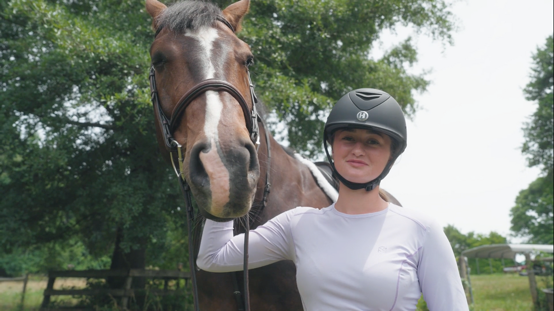 rider wearing One K MIPS helmet standing next to horse