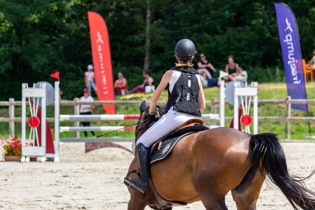 rider wearing equestrian air vest while riding horse
