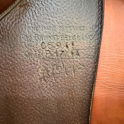 Close-up of a leather product with embossed text and branding.