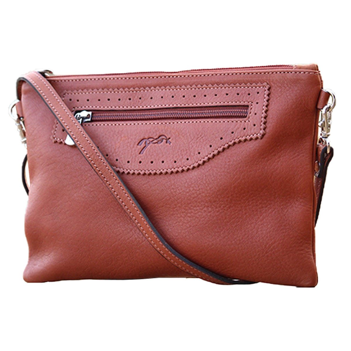 Penelope Emma Handbag: A small, notched handbag with a leather strap and a zippered front pocket, in Brandy.